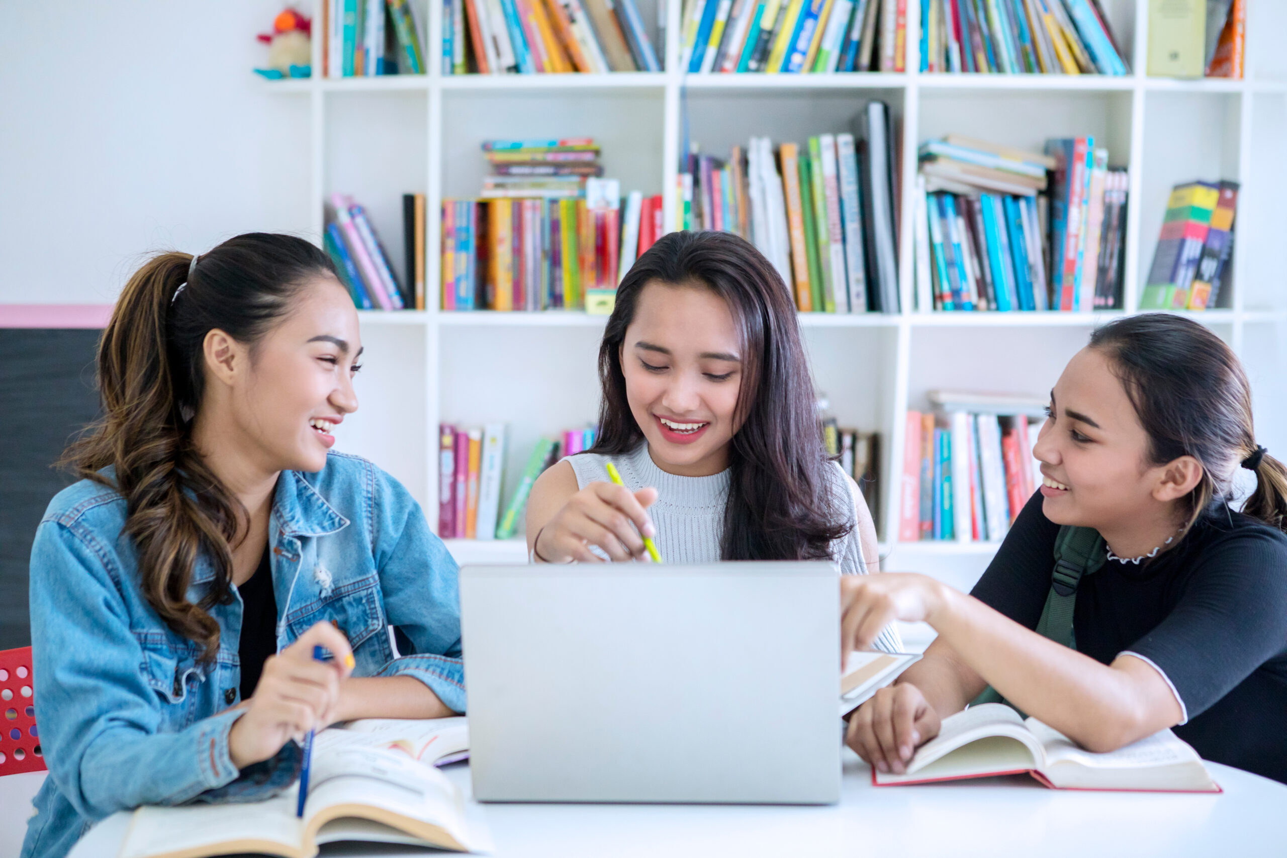Group of female teenagers studying in the library Youth In Philanthropy